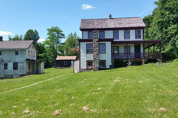 52-acre historic agricultural complex with a historic farmhouse, tenant house, smokehouse, and a carriage barn, all located on a rolling property with surrounding farmland