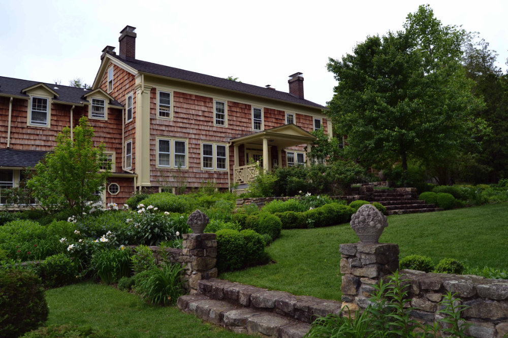 historic Colonial Revival house surrounded by gardens