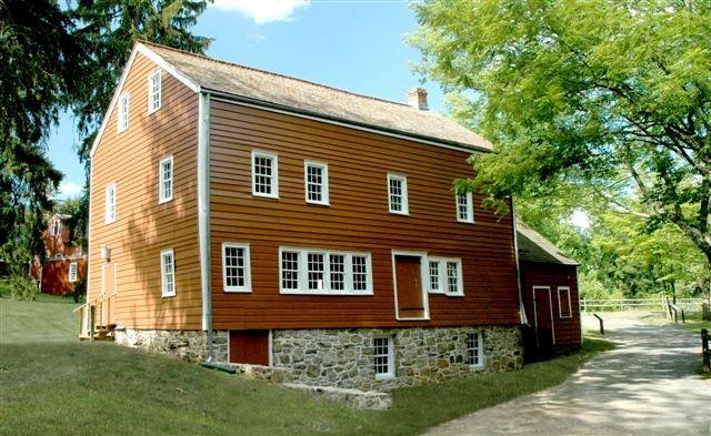 A simple red historic building on a slight incline