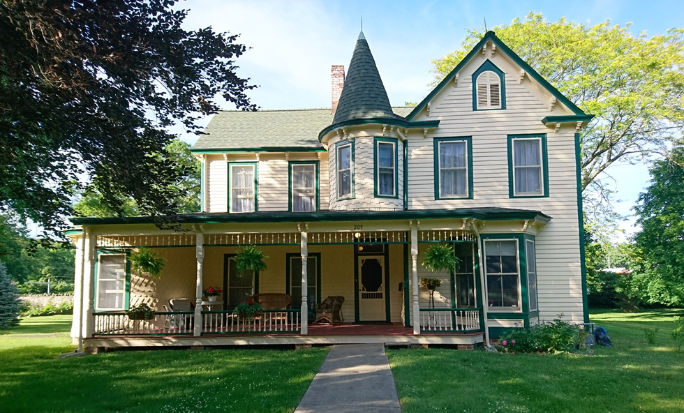 white historical home with green accents 