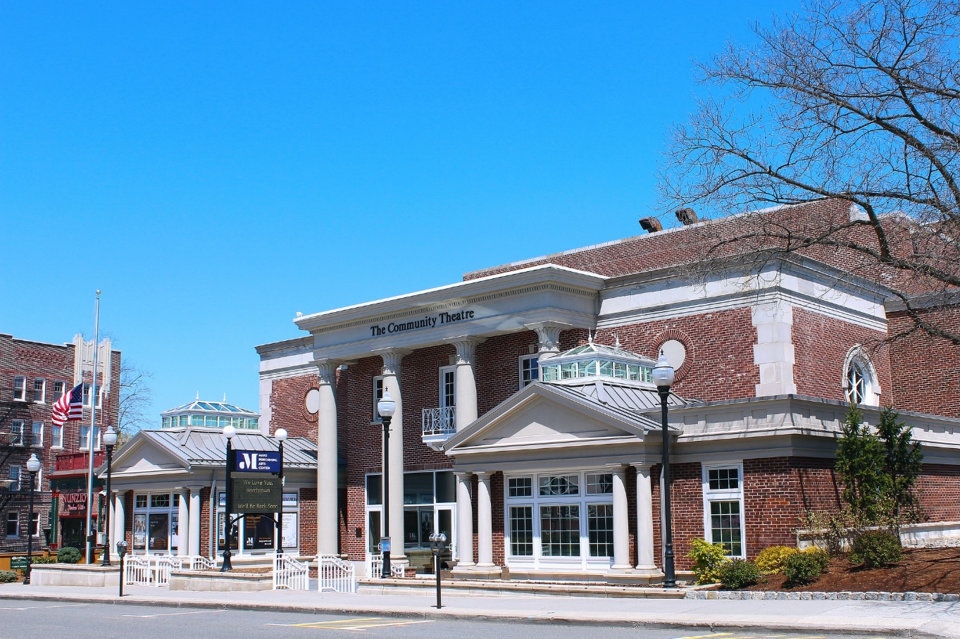 a historic brick building on a city street that says "the Community Theatre"