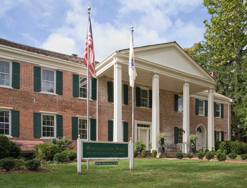 a historical brick building with white pillars in front